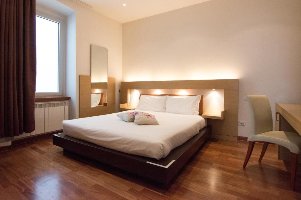 een slaapkamer met een groot bed met verlichting bij Residence Victoria in Trieste