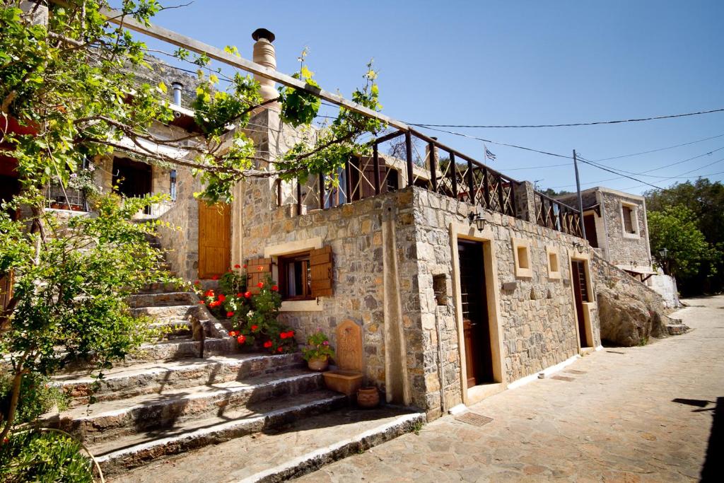 an old stone building with stairs in front of it at Monastiraki Traditional Guest House in Monastirákion