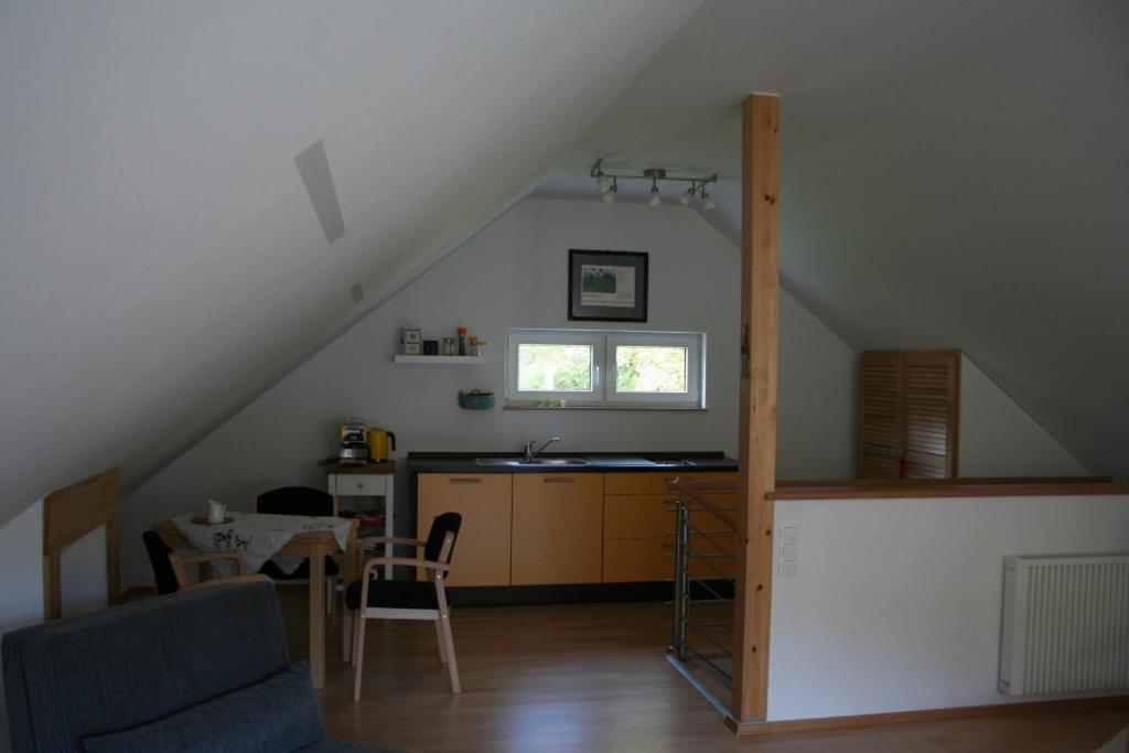 a living room with a kitchen and a dining room at Ferienhaus Kaiser in Branchewinda