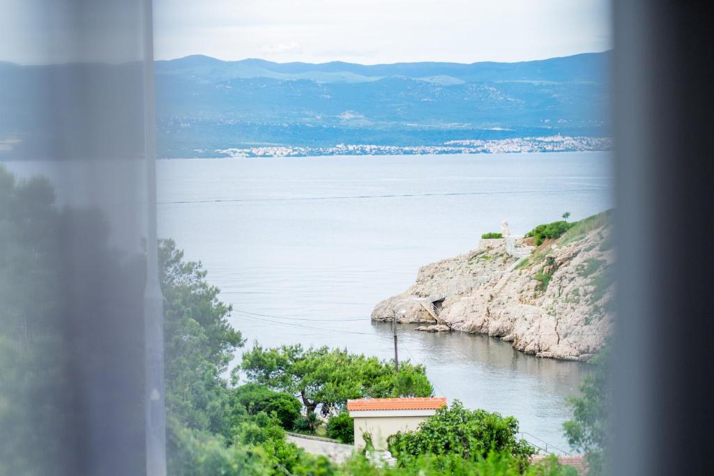 a view of a body of water from a window at Apartments Stasic in Vrbnik