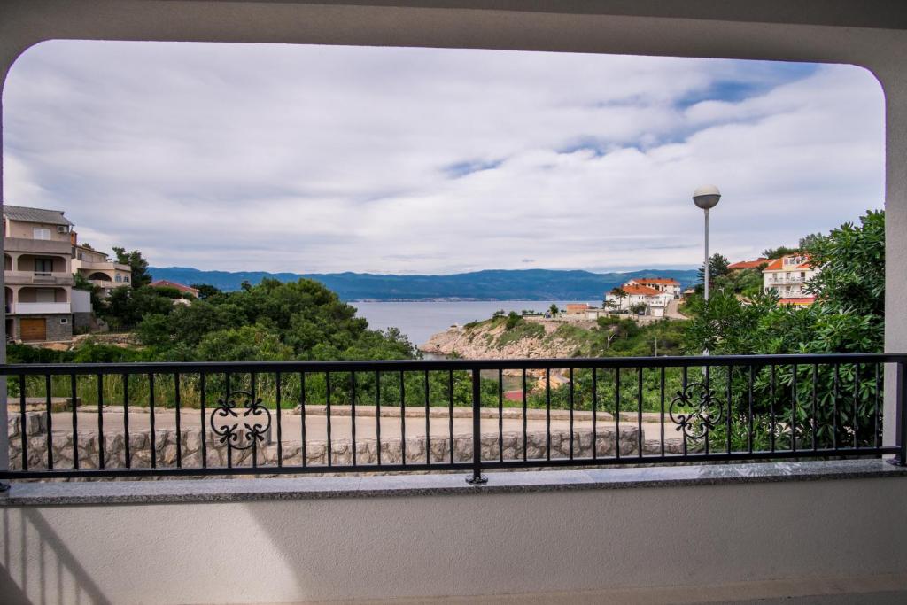 a balcony with a view of the water at Apartments Stasic in Vrbnik