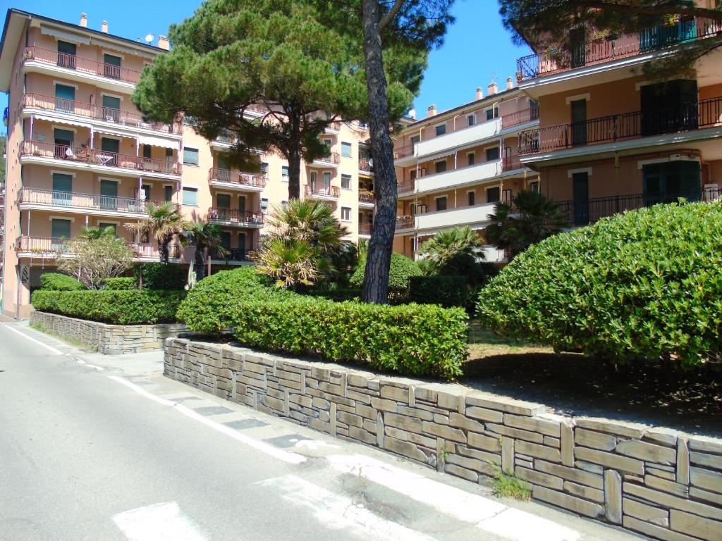 a street in front of a building with trees and bushes at Deiva Holidays in Deiva Marina
