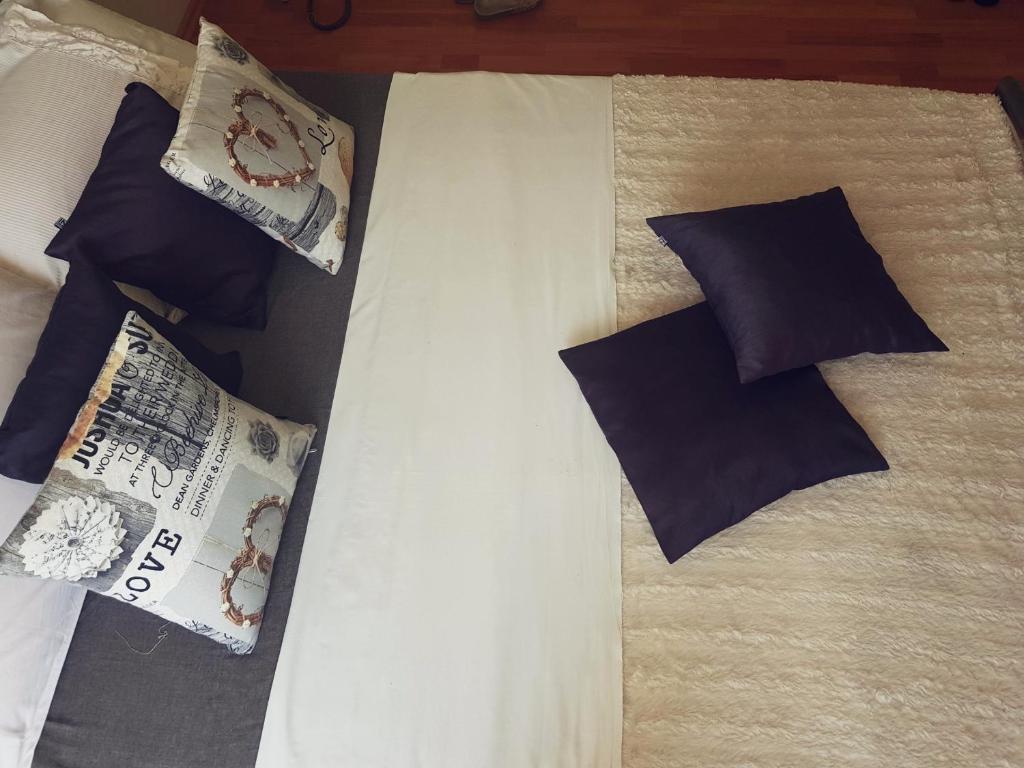 a bed with pillows and a newspaper on it at Apartment Lovre in Split