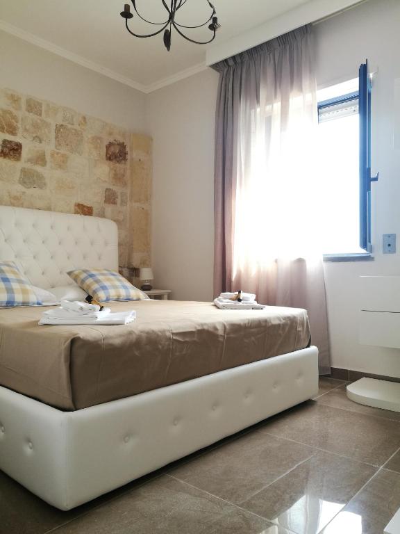 Postel nebo postele na pokoji v ubytování Hotel Residence La Corvetta
