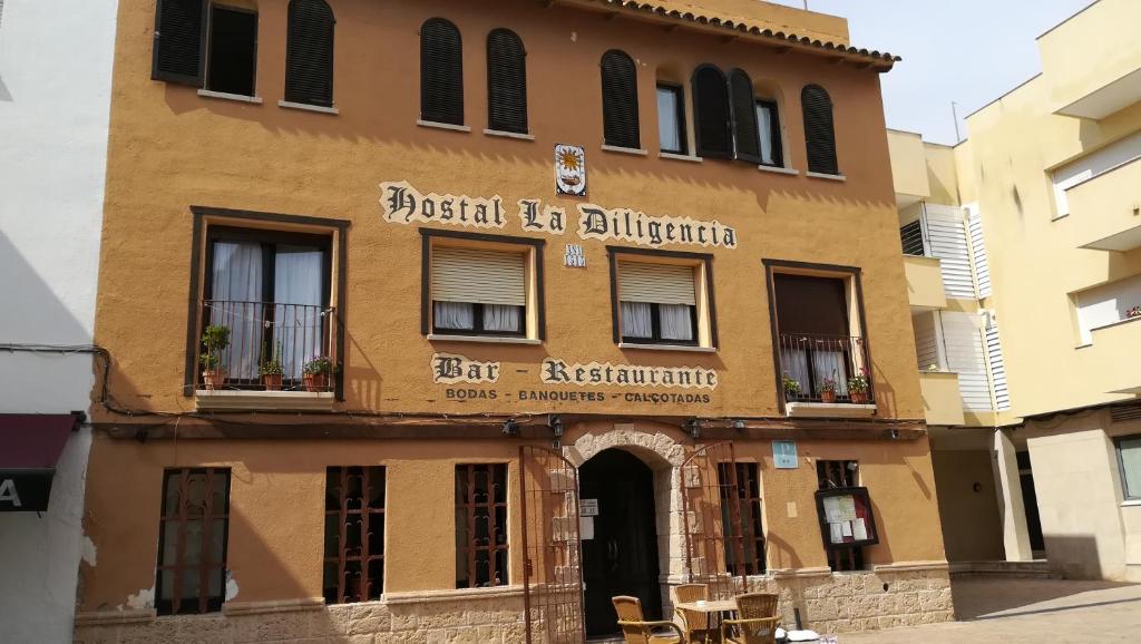 a building with a sign on the front of it at Hostal Restaurante La Diligencia in Cunit