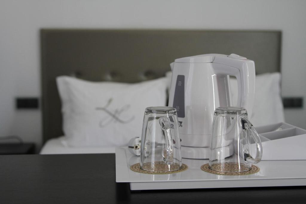 Postel nebo postele na pokoji v ubytování Lazza Hotel