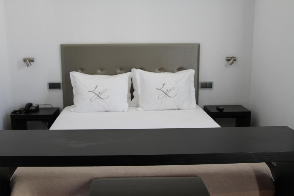 Postel nebo postele na pokoji v ubytování Lazza Hotel