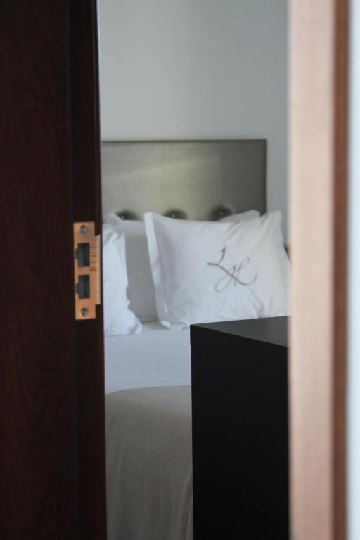 Postel nebo postele na pokoji v ubytování Lazza Hotel