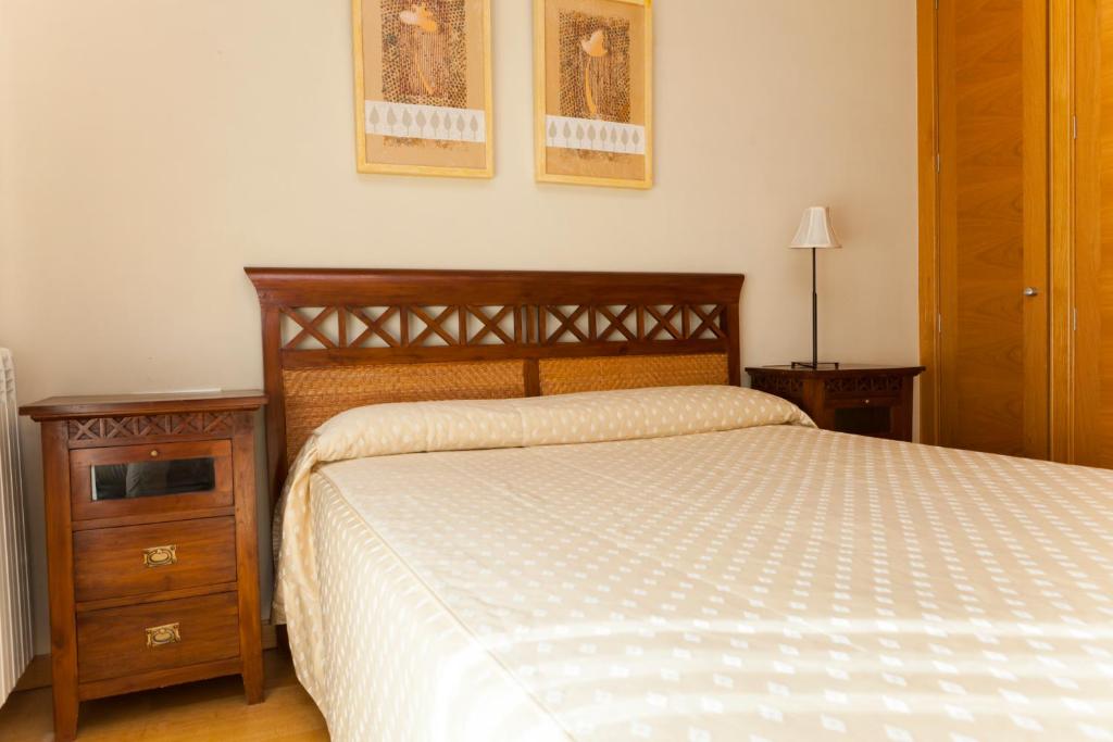 A bed or beds in a room at Apartamentos Tres Luces