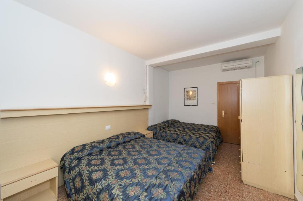 Postel nebo postele na pokoji v ubytování Hotel Primo
