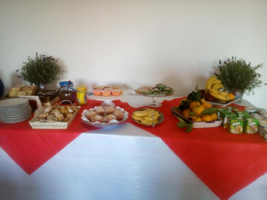 a table with food on a red table cloth at Valeri 's Country House in Sperlonga