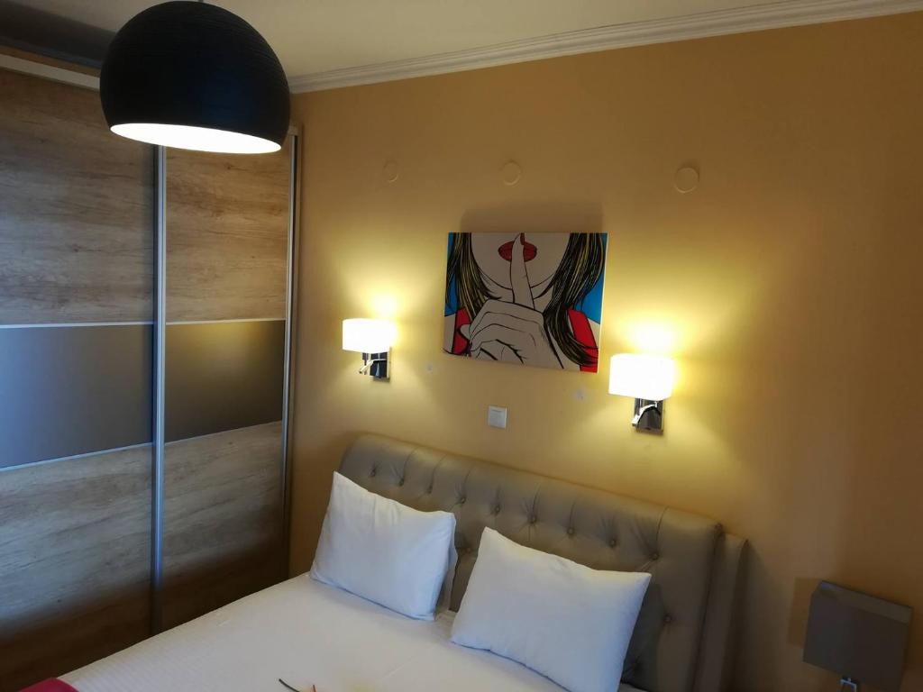 Postel nebo postele na pokoji v ubytování Olympic Hotel