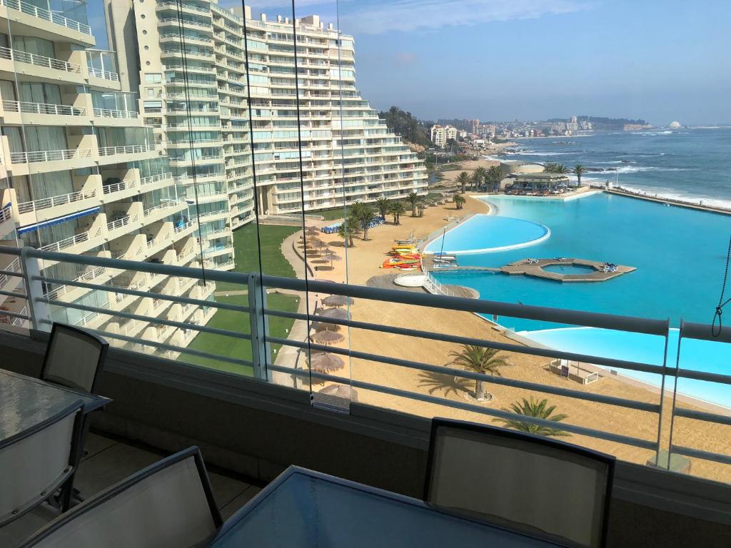 a balcony with a view of a beach and buildings at San Alfonso del Mar 802 in Algarrobo