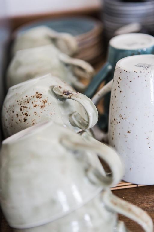 a group of white cups sitting on a table at Murella Living in Marsalforn