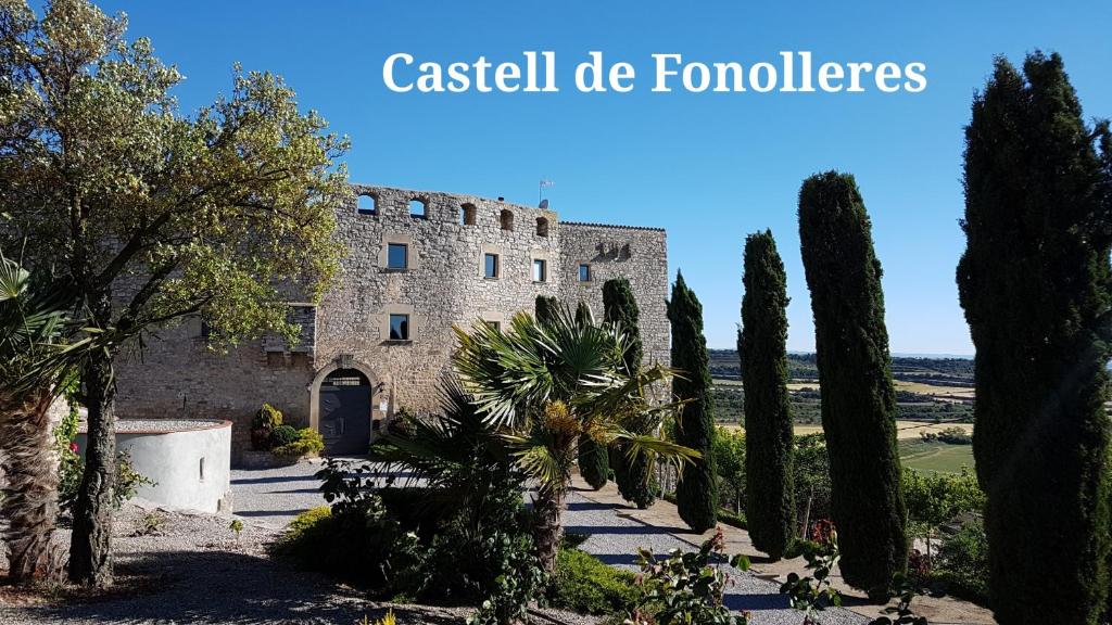 a building with a bunch of trees in front of it at Castell de Fonolleres in Fonolleres
