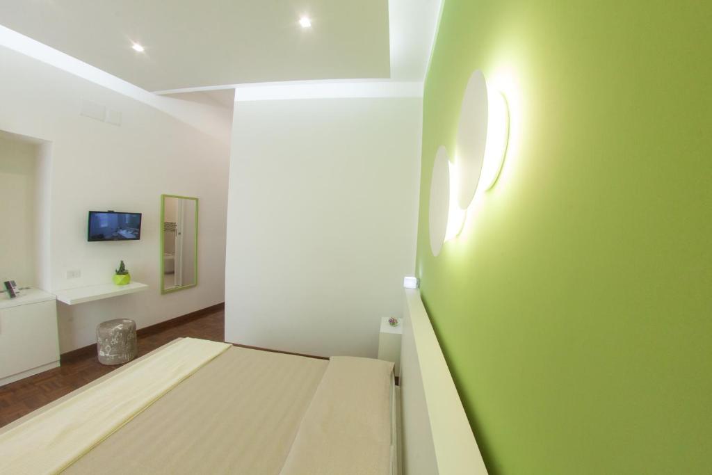 una camera con un letto e una parete verde di 319 al Duomo a Napoli