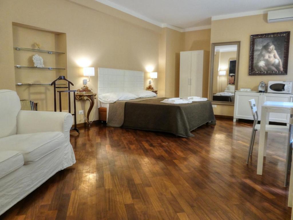 - une chambre avec un lit et un salon dans l'établissement Appartamenti Pratello, à Bologne