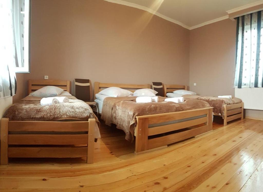 a bedroom with three beds in a room at Kazbegian Host in Kazbegi