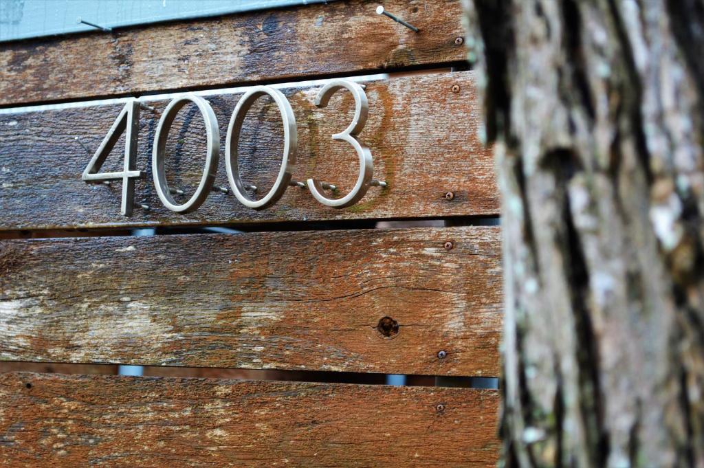 a wooden house with the number written on it at Modern B & B in Houston