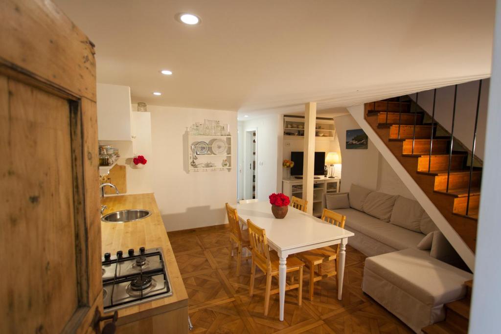 a kitchen and living room with a table and a couch at Barbarossa House with parking in Cres