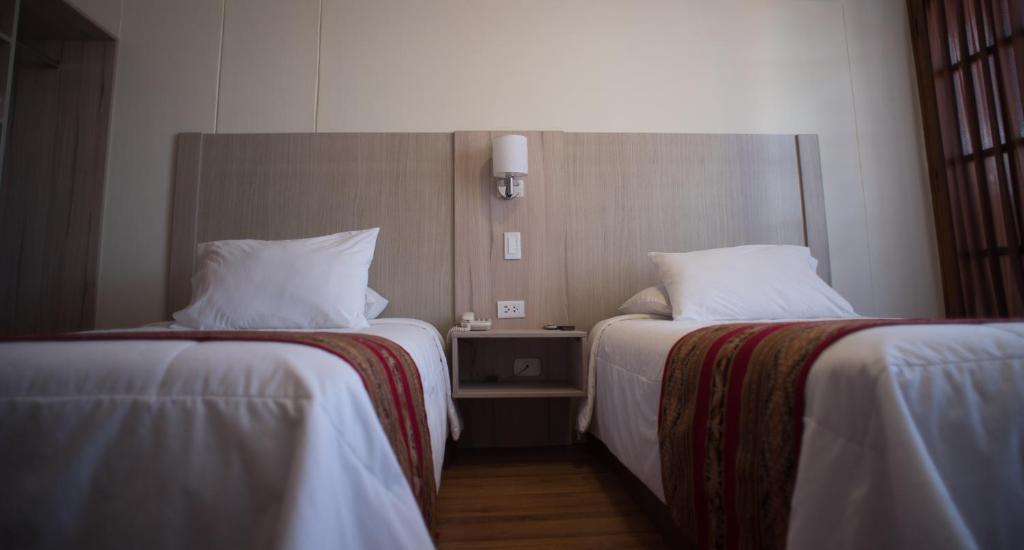 Postel nebo postele na pokoji v ubytování Hotel Prisma Cusco
