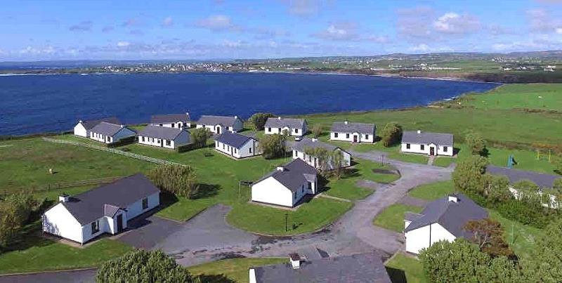 an aerial view of a house near the water at Quilty Holiday Cottages - Type A in Quilty