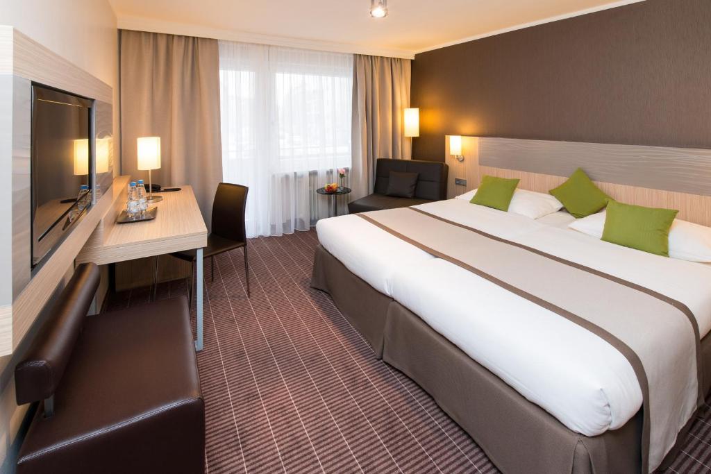 Postel nebo postele na pokoji v ubytování Hotel New Orly