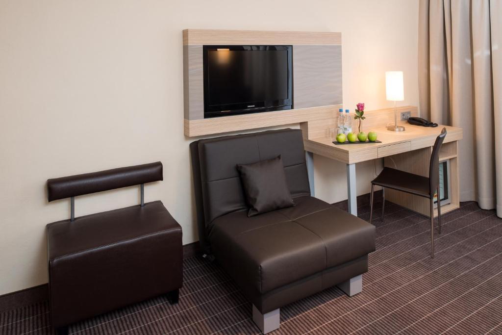 TV a/nebo společenská místnost v ubytování Hotel New Orly
