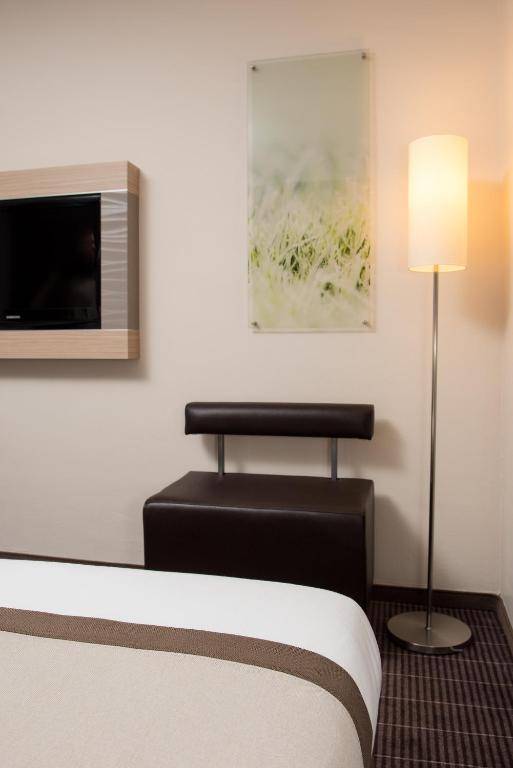 TV a/nebo společenská místnost v ubytování Hotel New Orly