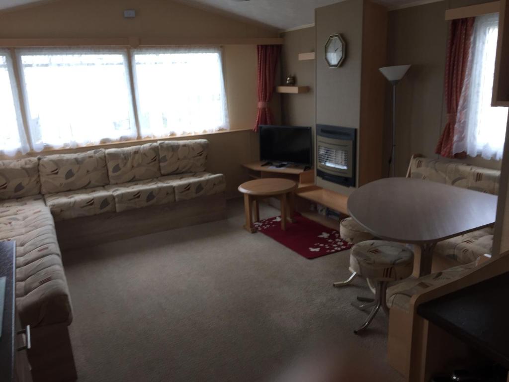 a living room with a couch and a table at Beach walk in Mablethorpe