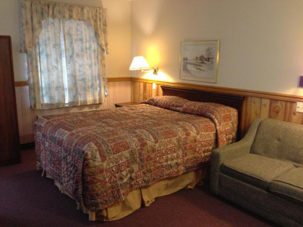 Postel nebo postele na pokoji v ubytování Rainbow Motor Inn