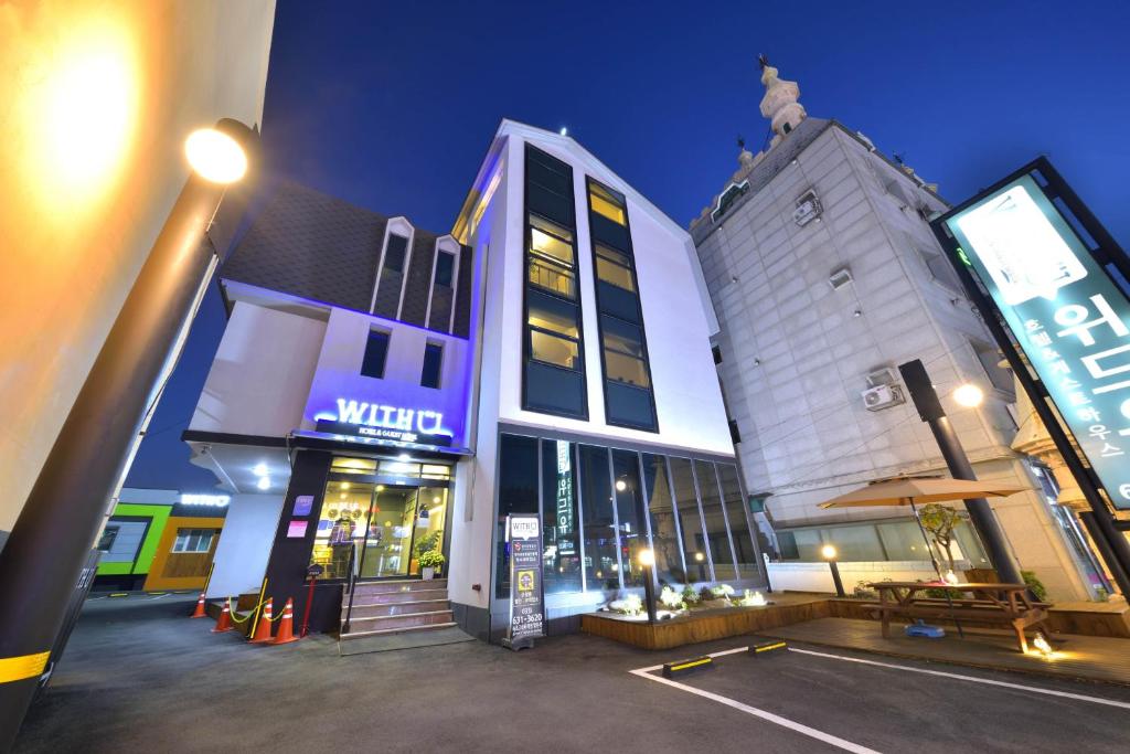 a building with a sign on the side of it at With U Hotel & Guesthouse in Sokcho