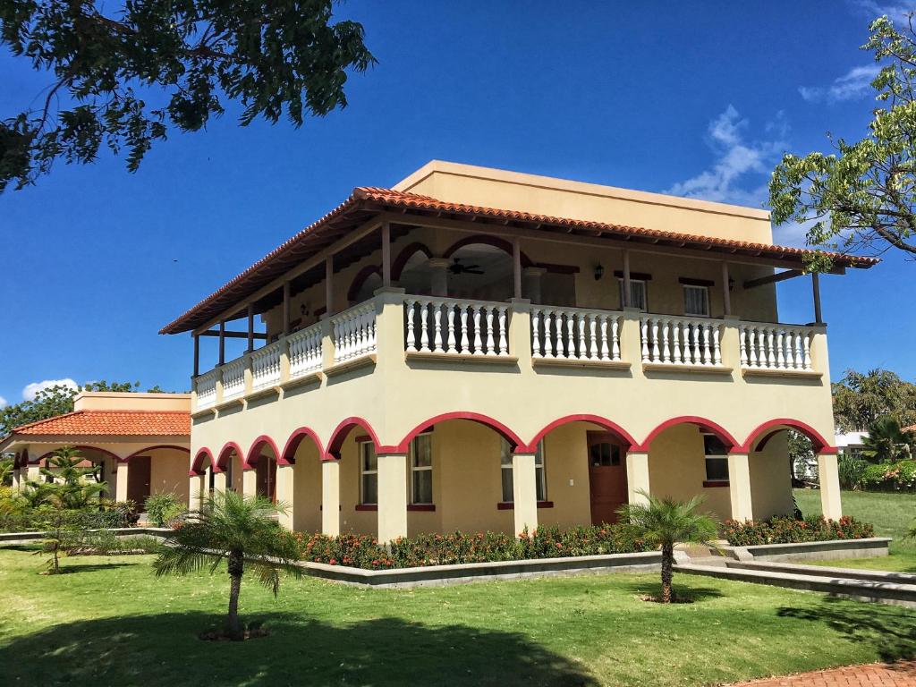 a large building with a balcony on top at Casa Taylor Gran Pacifica Resort in San Diego