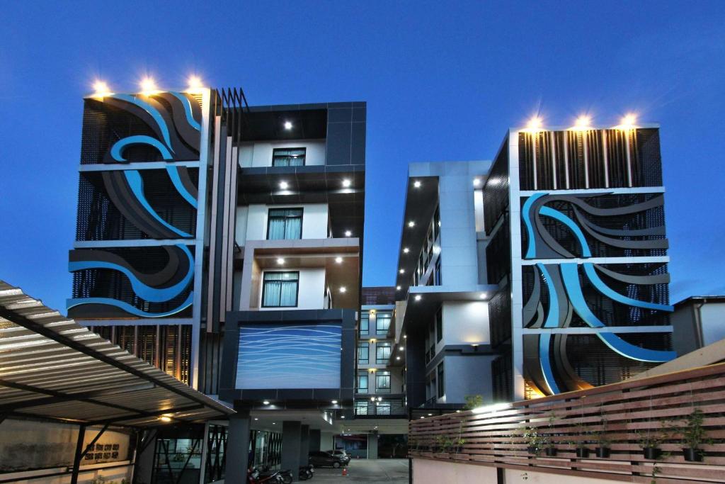 a building with two tall buildings with lights on at Thanburi Hotel in Udon Thani