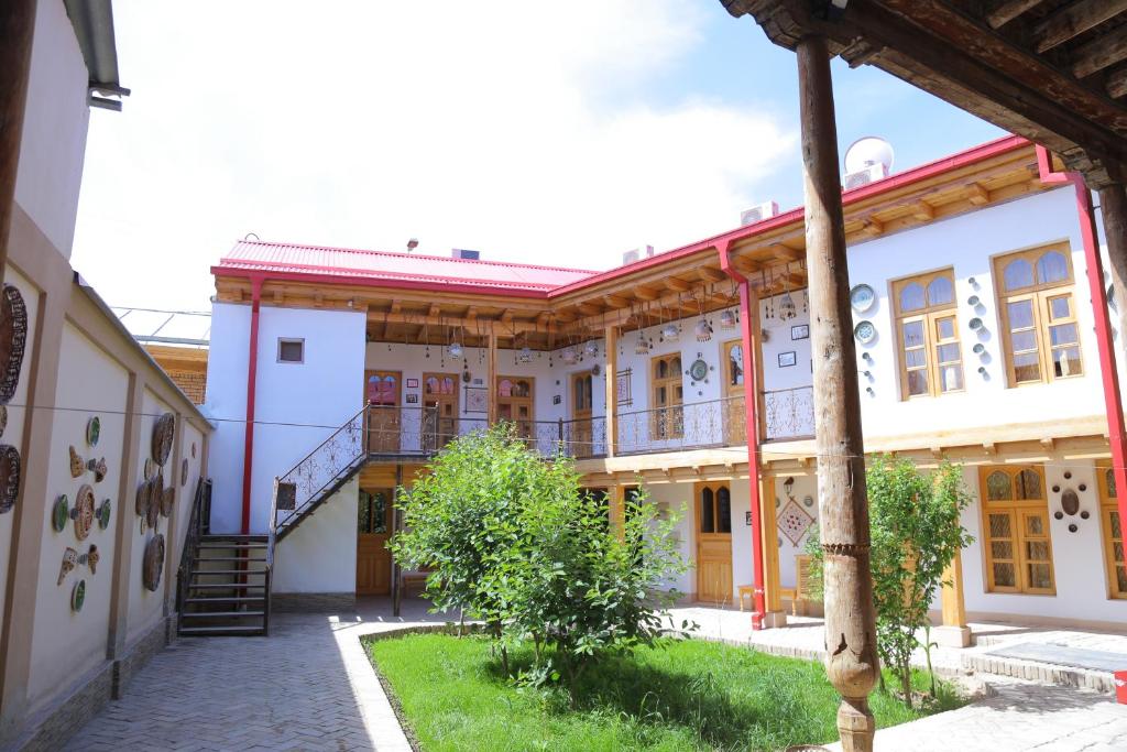 an old building with a staircase in a courtyard at Rabat Boutique Hotel in Samarkand