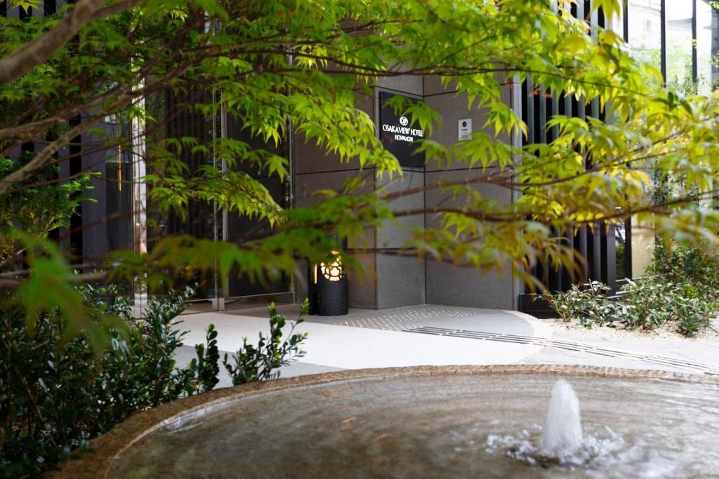 a water fountain in front of a building at Osaka View Hotel Honmachi in Osaka