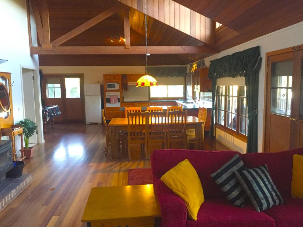 a living room with a couch and a dining room at Blackwattle at Barrington Tops in Bandon Grove