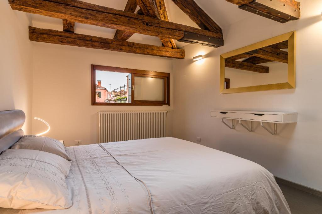 a bedroom with a white bed and a window at SAINT MARK'S BASILICA @200 meters in Venice