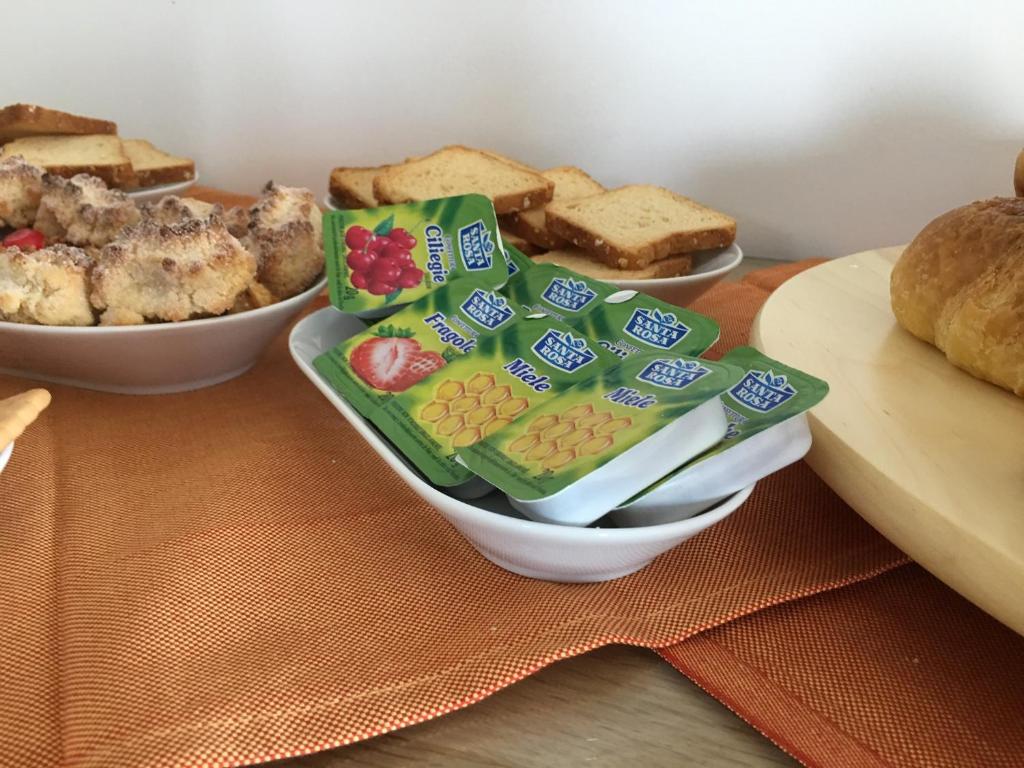 a table with a plate of bread and other foods at Daedalium in Marina di Palma