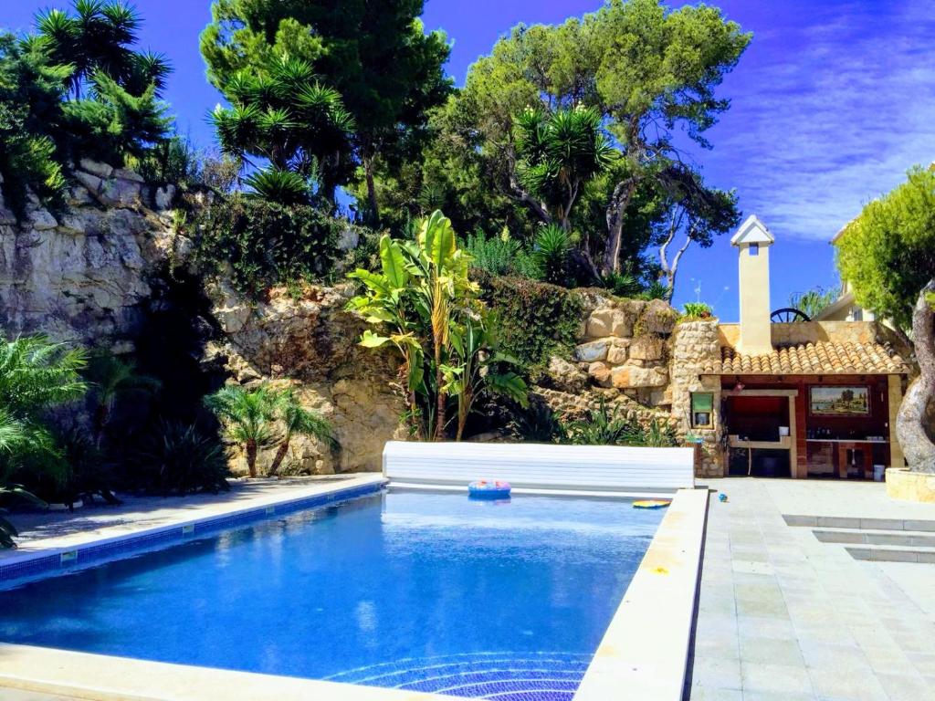 a swimming pool in front of a villa at El Collado in Cullera