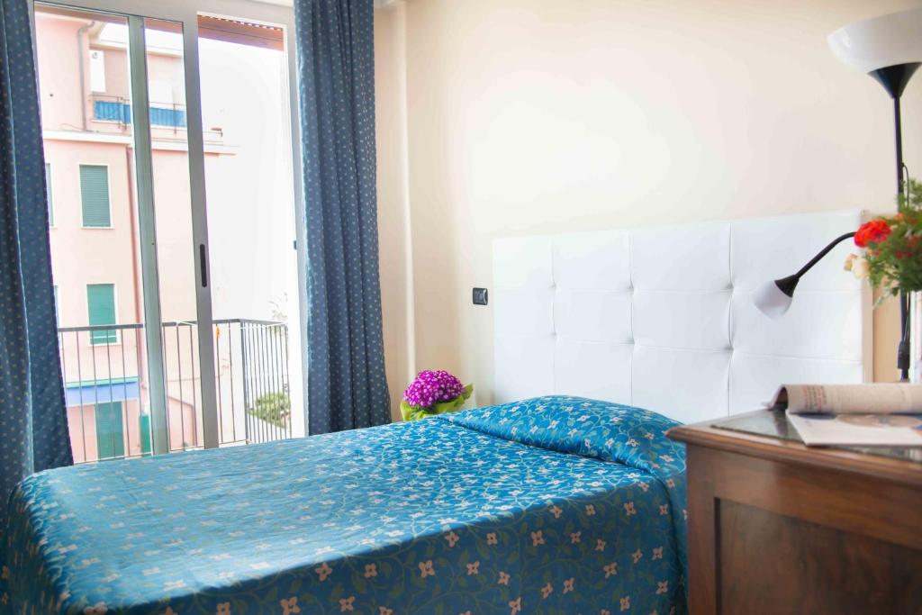 Łóżko lub łóżka w pokoju w obiekcie Hotel Elisabetta