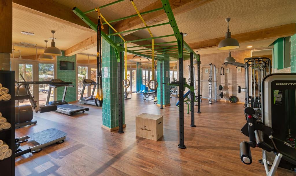 a gym with a bunch of equipment in a room at H10 Playa Esmeralda - Adults Only in Costa Calma
