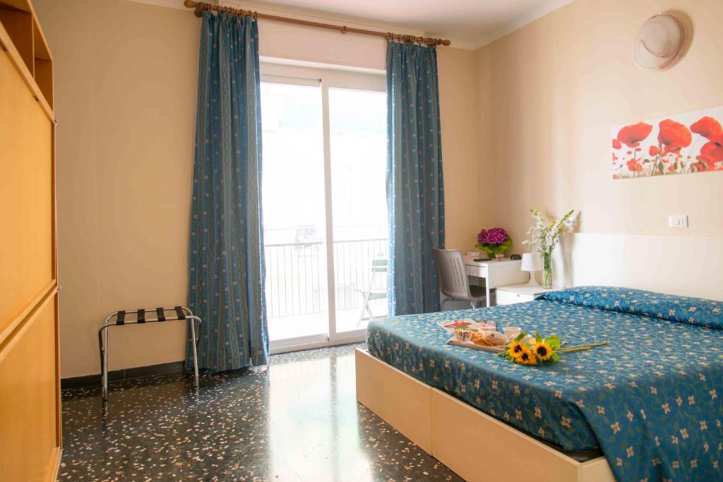 Łóżko lub łóżka w pokoju w obiekcie Hotel Elisabetta