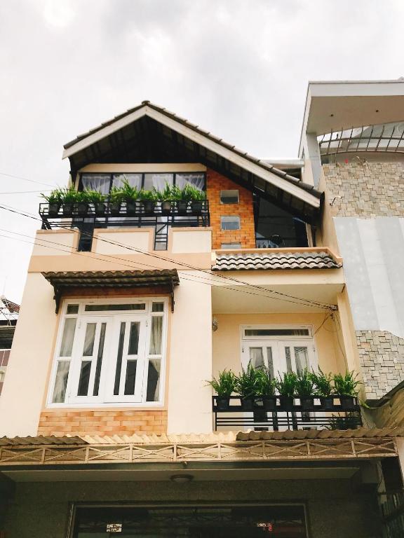 a house with potted plants on the balconies at lamphuonghouse in Da Lat
