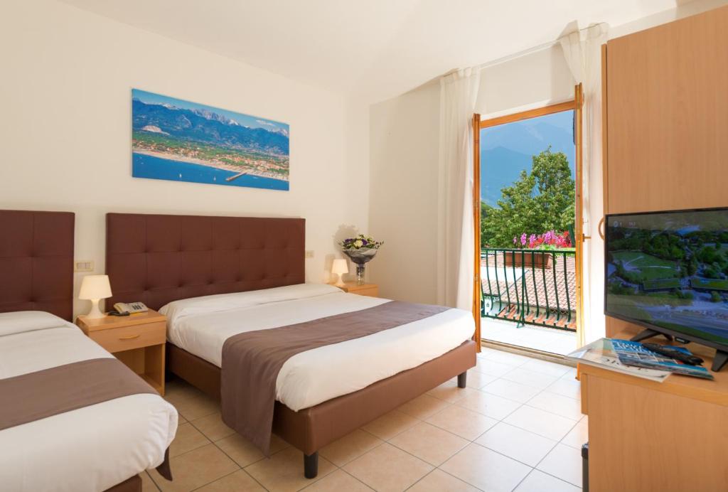Postel nebo postele na pokoji v ubytování Hotel La Pace