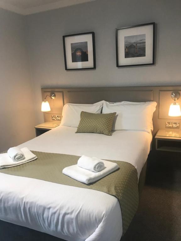 
a hotel room with a bed and a lamp at The Bridge Tavern in Wicklow
