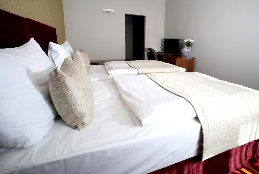 Postel nebo postele na pokoji v ubytování Hotel Central
