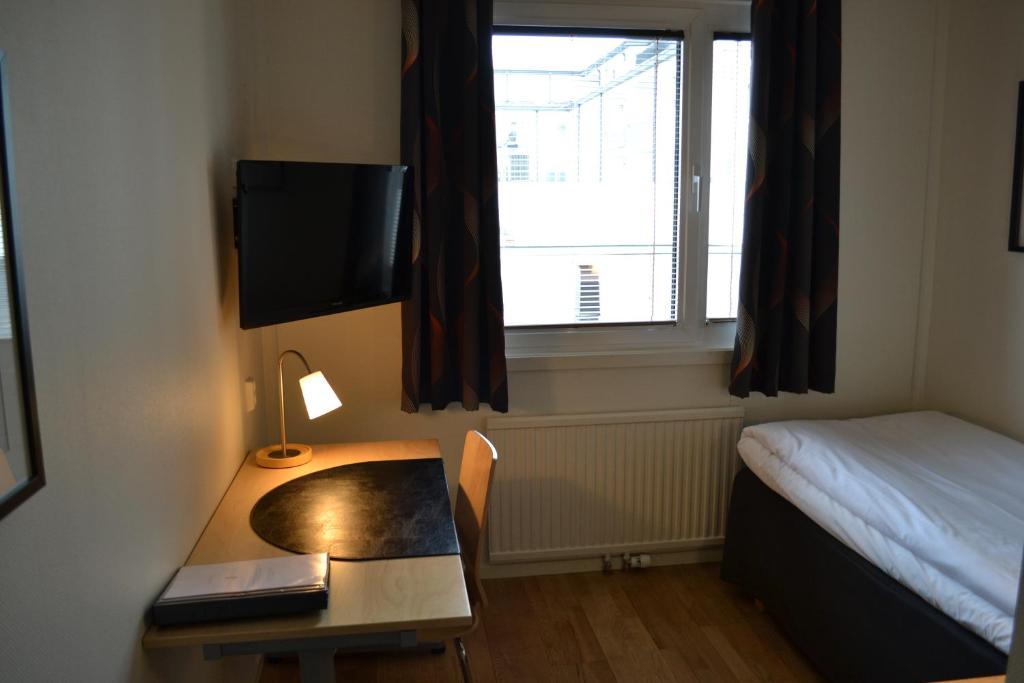 Postel nebo postele na pokoji v ubytování Centralhotellet