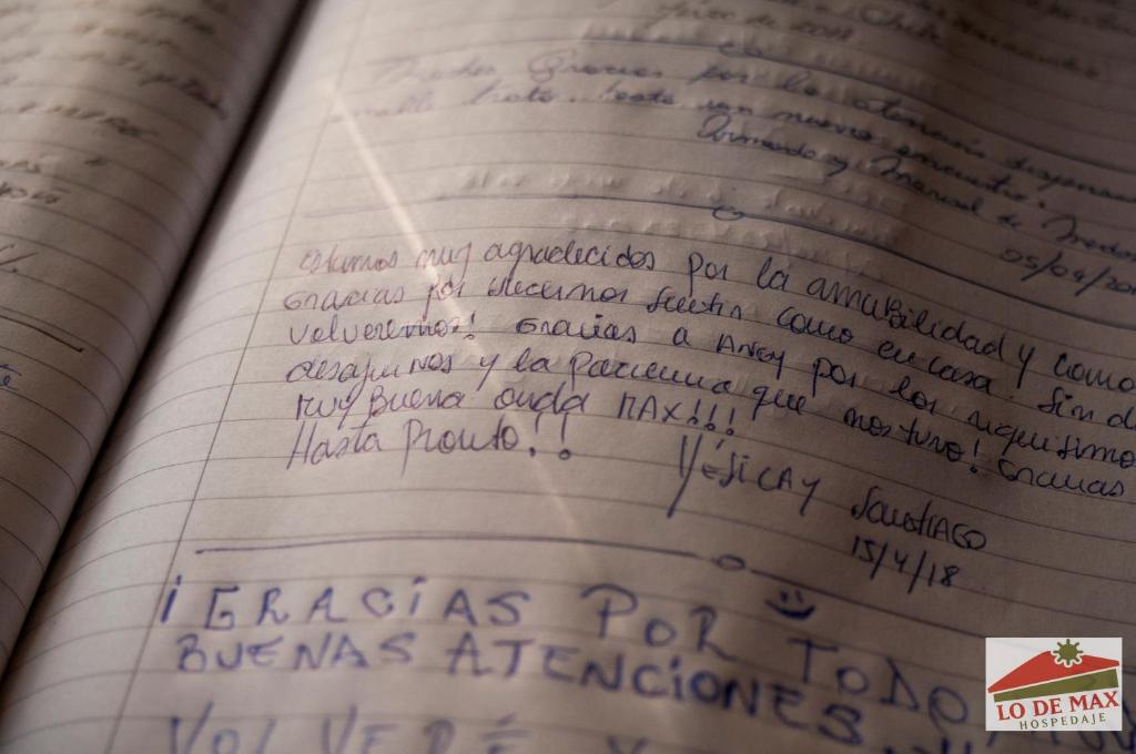 an open book with handwriting on the pages at Hospedaje Lo de Max in San Carlos de Bariloche