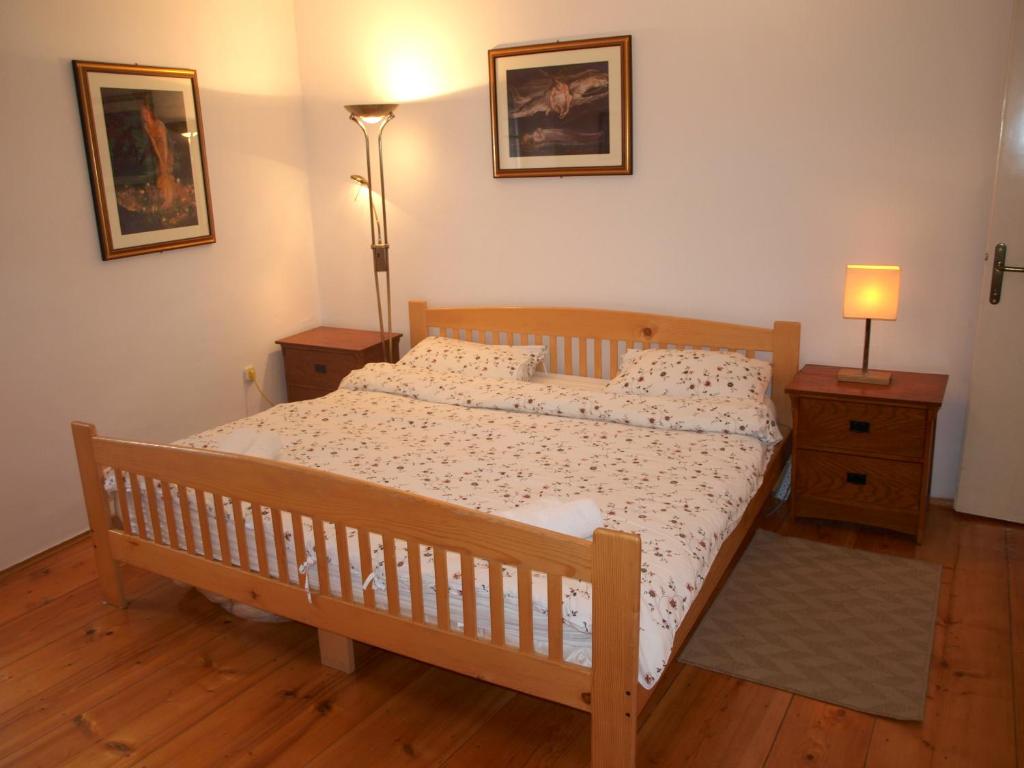 a bedroom with a wooden bed and two night stands at Apartment 11 in Rovinj